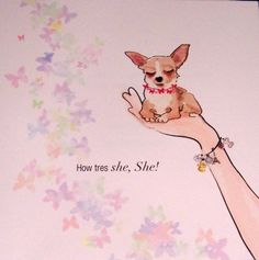 a hand holding a small dog on top of a card