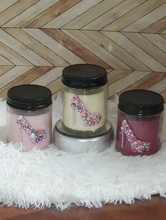 three jars with designs on them sitting on a rug