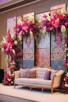 a couch and some flowers on a stage