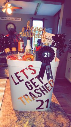 a bucket filled with lots of liquor on top of a counter