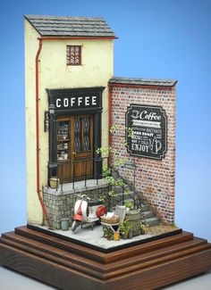 a miniature model of a coffee shop on display