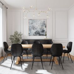 a dining room table with black chairs and a large painting on the wall above it