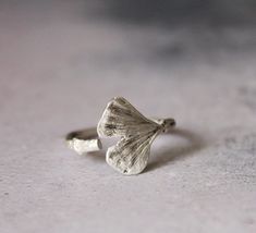 Adjustable sterling silver ginkgo leaf ring. This ring has been made from a real ginkgo leaf , using an ancient technique of lost wax method then I turn it into Sterling silver. If you love organic and nature inspired jewelry this one is ideal for you. Every piece is handmade by me This ring is adjustable. Make it yours or turn it into a great gift! Approximately 3/4 inch or 1.9 cm long and 5/8 inch or 1.6 cm wide You may also like : https://www.etsy.com/listing/183446699/egst-for-good-action-ginkgo-leaf-pendant?ref=shop_home_active_14 Caring instructions: As the ring are made from sterling silver, please keep them in a box or pouch, to avoid darkening. In such a case they can be easily cleaned, with a soft cloth and sterling silver polisher. For more rings: https://www.etsy.com/shop/CyKLu Plant Rings, Botanical Ring, Cactus Jewelry, Succulent Jewelry, Cast Rings, Silver Leaf Ring, Organic Jewelry, Organic Rings, Ginkgo Leaf