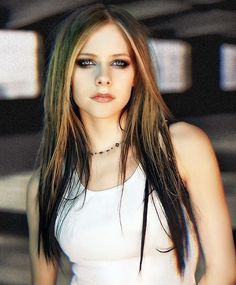 a woman with long hair wearing a white top