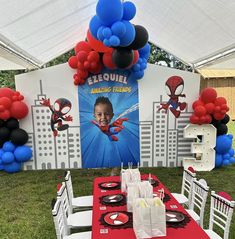 a table set up for a spiderman birthday party