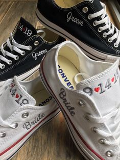 three pairs of black and white converse shoes with the word love written on each shoe