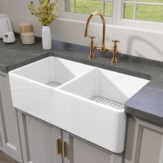 a large white kitchen sink sitting on top of a counter