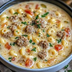 a bowl of soup with meatballs and tomatoes