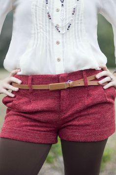 These red textured shorts feature two front pockets, two buttoned back pockets, a front zipper and double hook closure, cuffs, front pleats, and belt loops. Fitted Bottoms With Belt For Day Out, Short Bottoms With Belt Loops For Fall, Short Fall Bottoms With Belt Loops, Fitted Shorts With Belt Loops For Day Out, High Waist Red Shorts For Fall, Fall Season Belted Short Bottoms, High-waisted Shorts With Belt Loops For Fall, High Waist Shorts With Belt Loops For Fall, Fall High Waist Shorts With Belt Loops