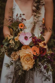 a woman holding a bouquet of flowers in her hands