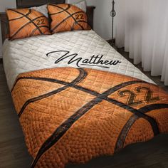 a bed with a basketball comforter and pillows