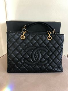 Authentic Chanel CC Black/Gold Caviar Quilted Grand Shopping Tote. Condition is "Pre-owned" and in excellent condition! This bag is gently used and in excellent preused condition💕 If you want a perfect bag that is new please shop retail! This is gently used with signs of use and priced reasonably based on that! Satin lined with multiple clean pockets💫 Some signs of wear on hardware and leather (minor scuffing on all four corners)💗 Authentic and purchased from authorized preowned retail💛 Come Channel Handbags, Louie Bag, Black Chanel Bag, High-end Black Shopping Bags, Chanel Shopper, Chanel Bags Black, Chanel Handbags Collection, Chanel Shopping Tote, Chanel Large Shopping Bag