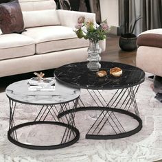 two tables sitting on top of a rug in a living room