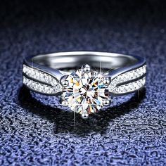 a diamond engagement ring on a blue surface