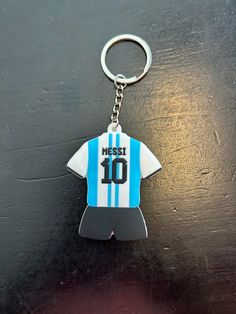 a soccer jersey shaped keychain with the number 10 on it's front