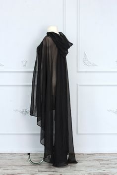 Gorgeous sheer black hooded cape made of tulle. It will make every your look mysterious and luxurious. The cape will be perfect for complementing your fantasy or gothic dress. It is possible to recreate this cape with other materials and coloring, just write to us, and we will choose the best fabric special for you. The standard back length is 55 inches (140 cm). If you want more or less, please, write to us. ♥See all cloaks and capes: https://etsy.me/2Qkhon8 =SHIPPING= We provide Standart airma Luxury Medieval Cape For Cosplay, Luxury Black Gothic Cosplay Costume, Cheap Black Cosplay Costumes, Black Sparkly Hooded Shawl, Luxury Gothic Cape For Costume, Luxury Black Cape For Formal Occasions, Elven Cape Dress, Long Black Wizard Robe, Luxury Elven Costume For Larp