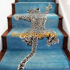 a blue carpeted stair case with an image of a woman in leopard print on it