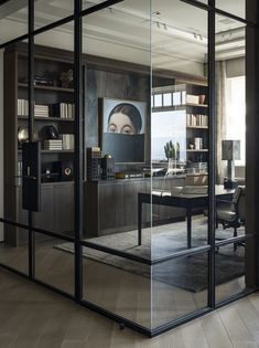 an office with glass walls and wooden floors