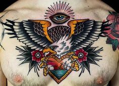 a chest tattoo with an eagle, heart and eye in the center on top of it