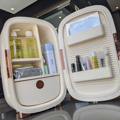 two white containers filled with different types of cosmetics and personal care items on top of each other