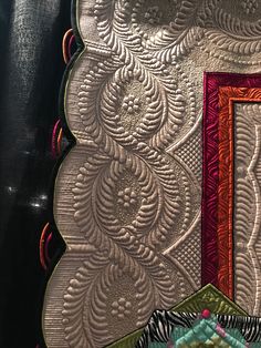 a close up view of a quilted wall hanging