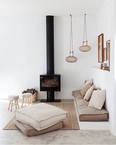 a living room filled with furniture and a fire place in the middle of the room