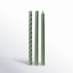 two green candles sitting next to each other