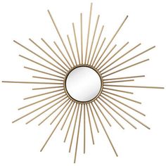 a gold sunburst mirror on a white wall