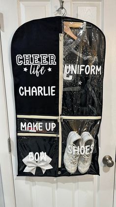 a pair of white shoes hanging from a door with black and white clothes on it