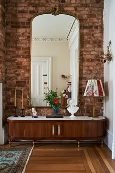 a large mirror sitting on top of a wooden table