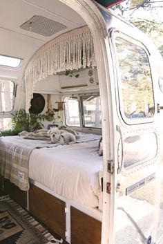 the interior of a camper with an open bed