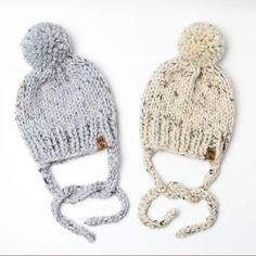 two knitted hats sitting next to each other