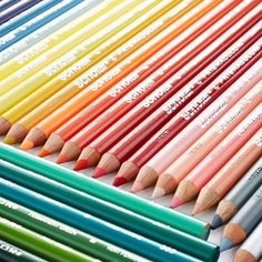 many different colored pencils lined up on top of each other