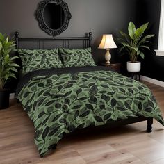 a bed with green and black comforters in a room