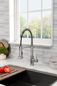 a kitchen sink with a faucet and cutting board in front of the sink