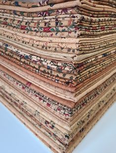 a pile of old rugs stacked on top of each other