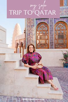 a woman sitting on steps in front of a building with text overlay that reads, my solo trip to qatar