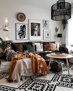 a living room filled with furniture and pictures on the wall