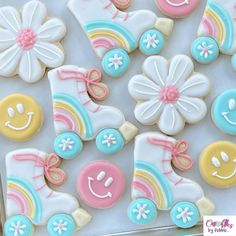 decorated cookies in the shape of baby booties and boots with rainbows, daisies, and flowers