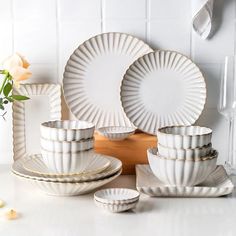 a white table topped with plates and bowls