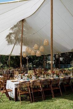 a large tent set up with tables and chairs