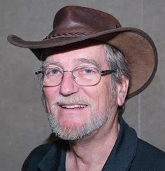 an older man wearing a brown hat and glasses