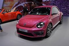 the volkswagen beetle is on display at an auto show