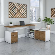 an office desk with two drawers and a laptop on it in front of a window