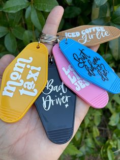 four different colored luggage tags with writing on them