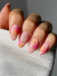 A pretty, elegant orange and pink nail look with dainty flowers. Products used to create this look are linked to this post 🌺☁️ Summer Nails Flowers Almond, Vacation Nails Pink And Orange, Nail Inspo Pink Almond, Pink And Orange Flower Nails, Vacation Nails Orange, Flower Nails Orange, Orange Flower Nails, Orange Pink Nails, Vacation Nails Summer