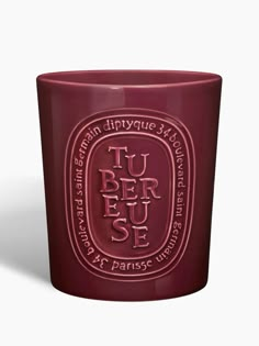 a red glass cup with the words tu ber jee on it's side