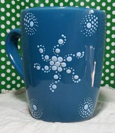 a blue coffee cup with white dots on it