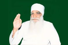 an old man with a white beard and long white hair is holding his hand up