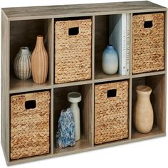 a shelf with baskets and vases on it